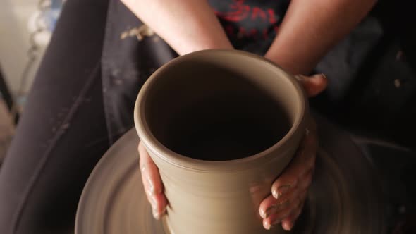 An Elderly Woman Senior Professional Potter in Workshop Makes Jug Out of Clay