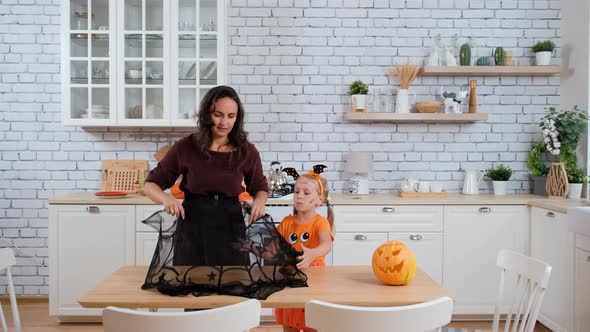 Mother with Daughter Decorate Table for Halloween alt