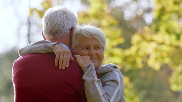 Middleaged Caucasian People Hug in the Park Woman Shows Her Face to the Camera Selective Focus Copy alt