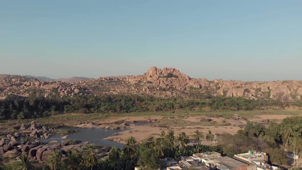 Rocky landscape and barren Tungabhadra Riverbank at Hampi town's edge, Karnataka, India alt