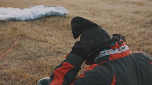 Pilot Putting Warm Textile Balaclava on Head Under Safety Helmet alt