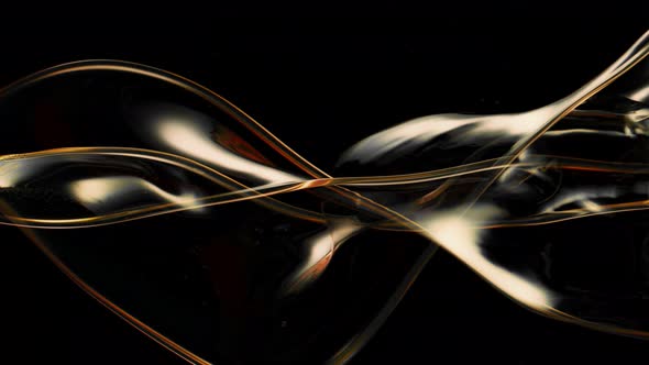 Super Slow Motion Shot of Swirling and Splashing Golden Oil Isolated on Black Background at 1000Fps alt