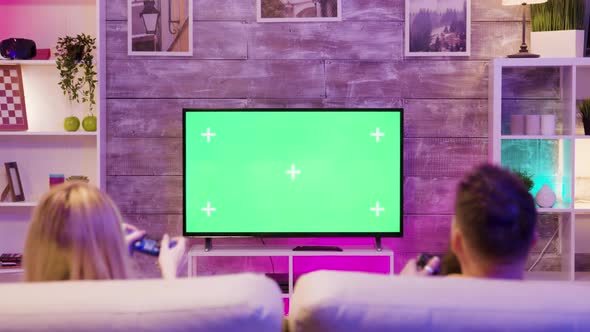 Brother and Sister Relaxing While Playing Online Games alt