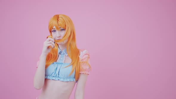 Cute European Fit Skinny Girl Flirts By Touching Her Ginger Shiny Hair Isolated Pink Background alt