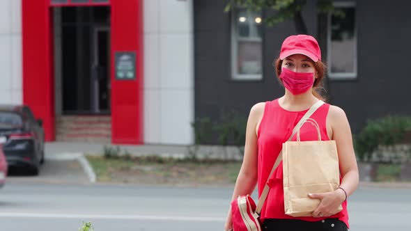 Portrait of a Courier Girl on the Street. alt