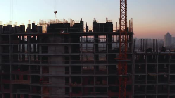 Aerial Shot of the Building in the Process of Construction. Labor Working in Big Construction Site
