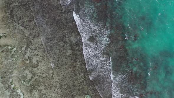 Aerial view of waves and sea crashing forming patterns in nature La Digue Seychelles