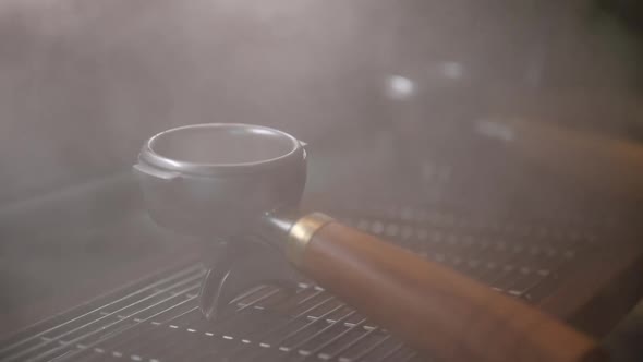 Portafilter boiling steam with coffee machine in coffee cafe, vintage filter image alt