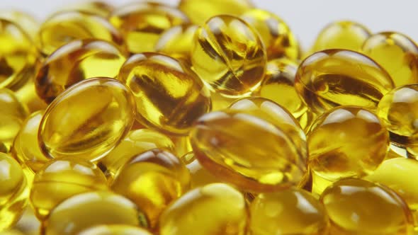 Macro View Omega 3 Gold Fish Oil Capsules Rotation Background