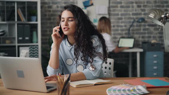 Cheerful Girl Talking on Mobile Phone Making Business Call in Office and Smiling alt