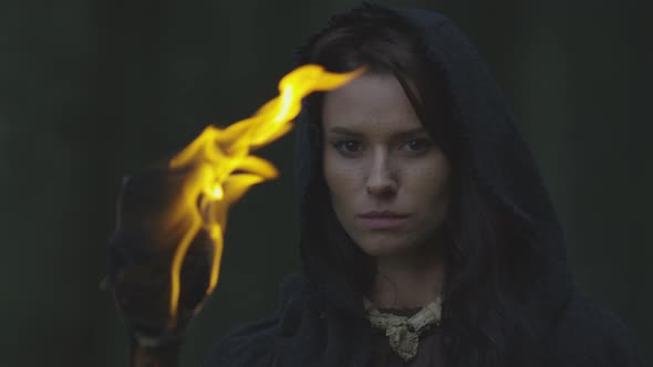 Close up of a woman with a fire torch alt