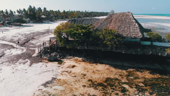 The Rock Restaurant in Ocean Built on Cliff at Low Tide on Zanzibar Aerial View alt