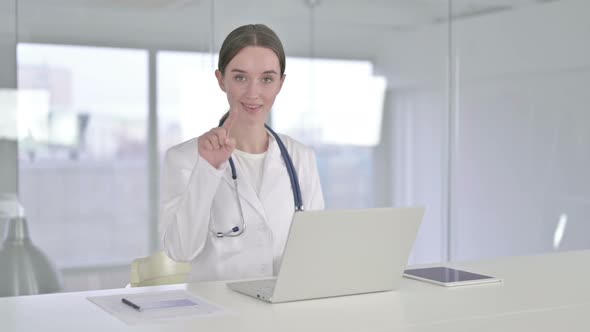 Attractive Young Doctor Doing Call Me Sign with Hand  alt