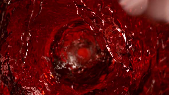 Super Slow Motion Shot of Red Wine Whirling in Glass Bottle at 1000Fps alt
