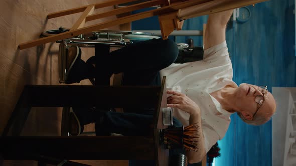 Vertical Video Old Artist with Physical Impairment Using Pencils to Draw Vase Sketch alt