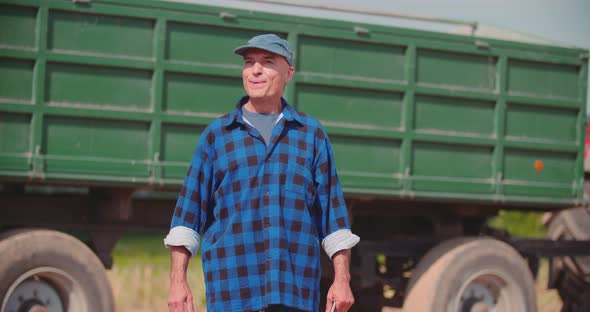Farmer Using Digital Tablet While Examining Field alt