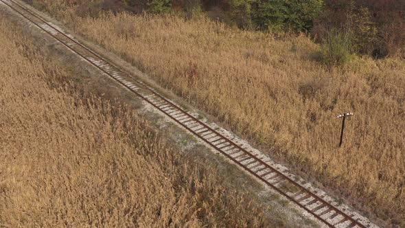 Above railroad line in a prairie 4K drone video