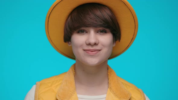 Portrait of Charming Young Woman in Trendy Yellow Hat alt