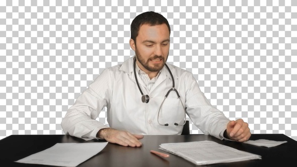 Aggressive disappointed doctor at a table, Alpha Channel