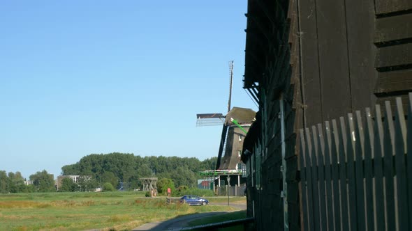 Travelling to the side revealing the windmill, Zaanse Schans, Netherlands alt