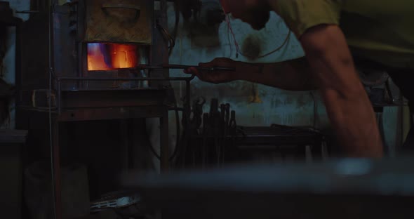 Blacksmith Working in Forge Heating Metal Workpiece in Special Furnace  Prores alt