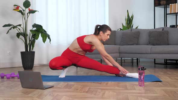 Fit Woman Watch Online Sport Webinar Laptop Doing Warmup Stretching Training