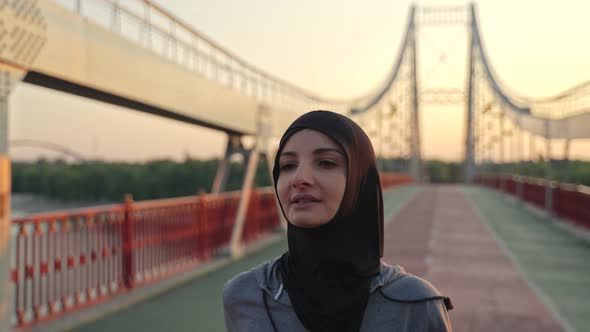 Fit Muslim Woman Wearing Hijab on Morning Jogging alt