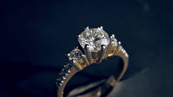 Extreme detailed of diamond ring close up shot while rotating on dark background alt