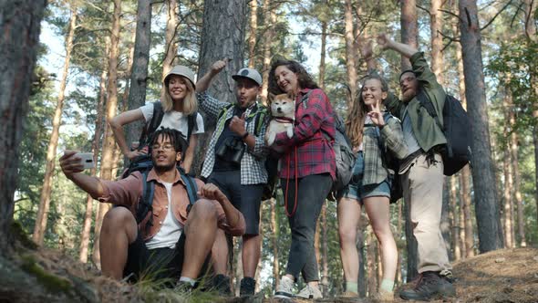 Cheerful Young People Tourists Taking Selfie with Smart Phone Camera Having Fun Posing with Hand alt