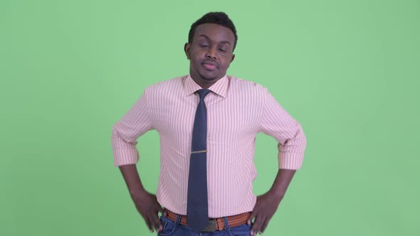 Stressed Young African Businessman Looking Bored and Tired alt