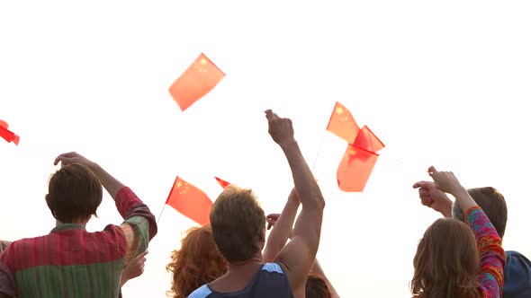 People Waving Chinese Flags Back View alt