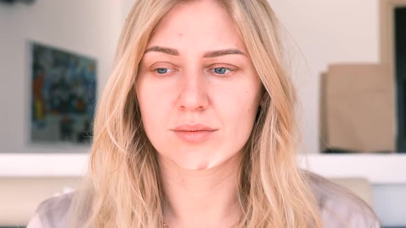 Young Beautiful Blueeyed Blonde Woman Without Makeup Looks Into the Camera