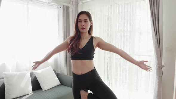 Asian women relax with yoga exercise and stretching in the living room alt