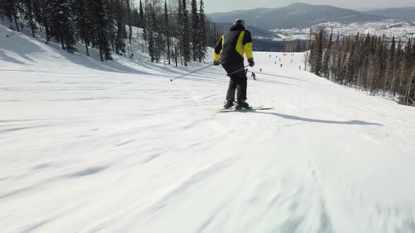 Young adult recreational skier enjoys idyllic perfect weather in winter