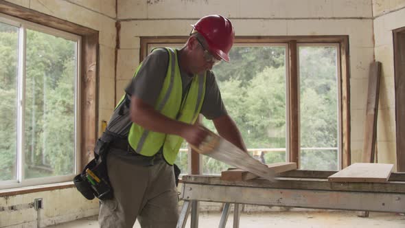 Construction worker cutting board with hand saw