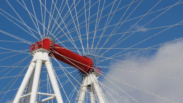 Amusement Ride Ferris Wheel on Blue Sky Background