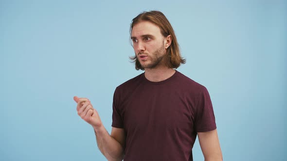 Young Guy is Listing Something Unbending His Fingers and Smiling Looking Satisfied While Posing on alt