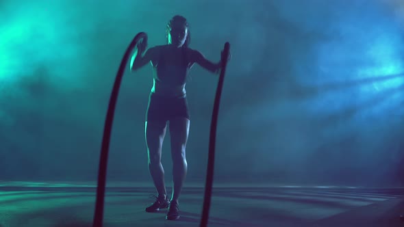 Muscular Brunette Woman Training with Ropes alt