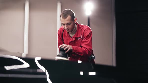 Polishing Black Car Surfacewith a Professional Polishing Mashine Using Wax alt