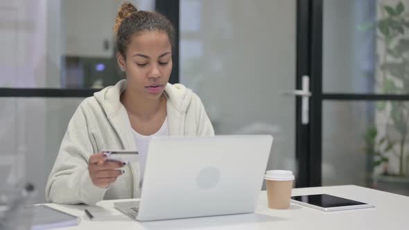 African Woman Making Online Payment Failure on Laptop in Office alt