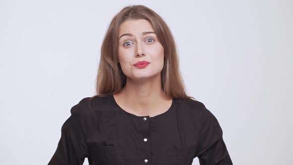 Young Beautiful Shocked Fairhaired Girl Over White Background Slow Motion alt