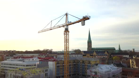 Aerial view of construction site of new residential building wint tower crane. alt