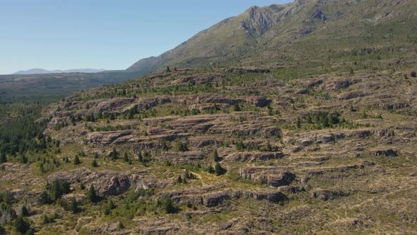 Aerial pan left of Andean mountains covered in vegetation near Epuyen lake, Patagonia Argentina alt