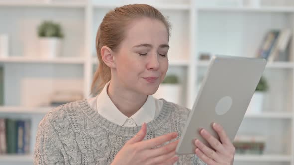 Portrait of Young Woman Reacting To Loss on Tablet alt