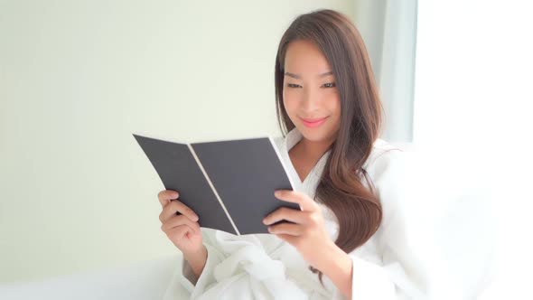 Young asian woman read book alt
