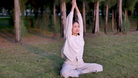 Asian woman outdoor yoga keep calm and meditate while practicing yoga