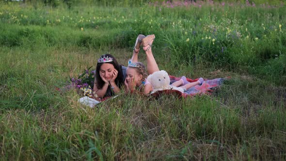 Mother Reading Tales for Daughter in Summer Field alt