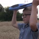 A happy boy launches a toy plane in a wheat field. Pilot of a children&#39;s plane. - VideoHive Item for Sale