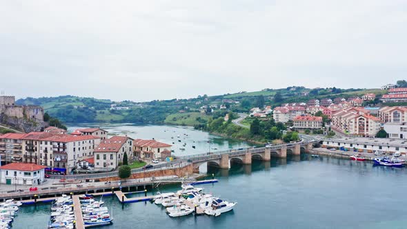 Scenic aerial view of traditional north spanish fishing village at both sides of sea entrance alt