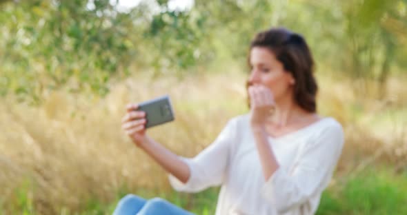 Woman taking selfie from mobile phone in olive farm 4k alt